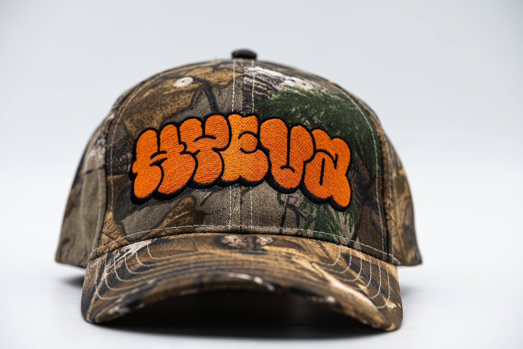 Real Tree Camo Cap with Orange HYEVA Logo
